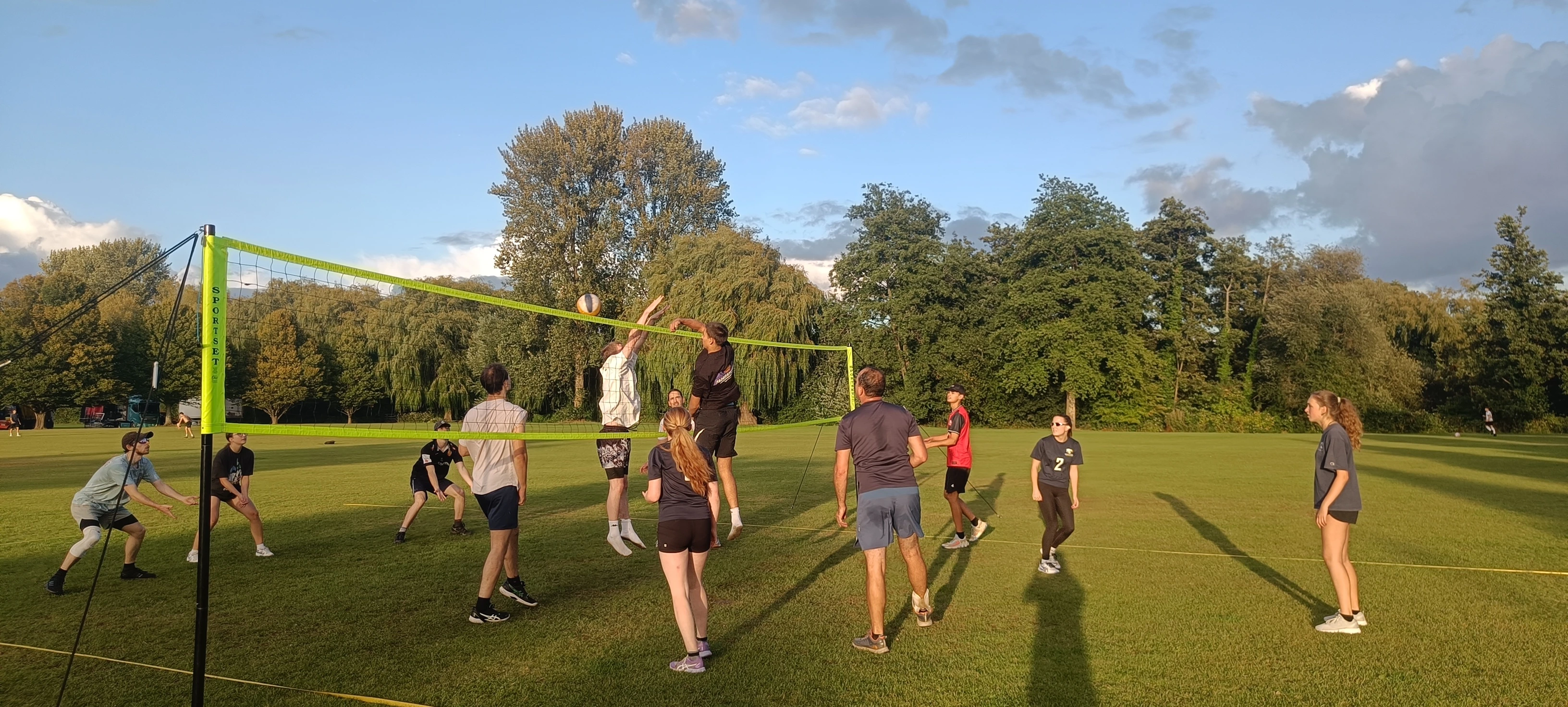 adults playing volleyball outdoor