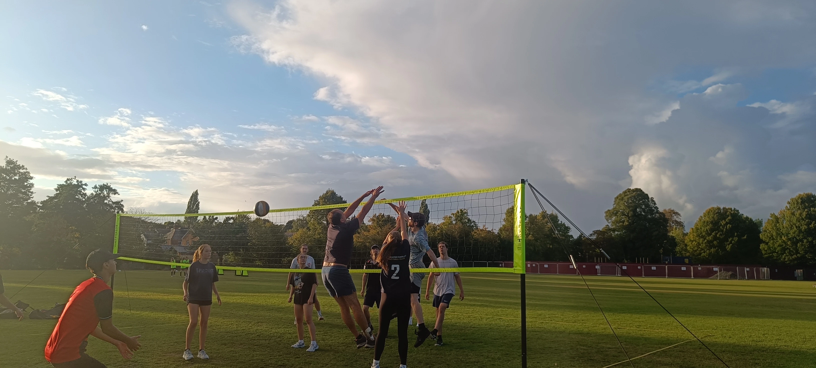 adults playing volleyball outdoor