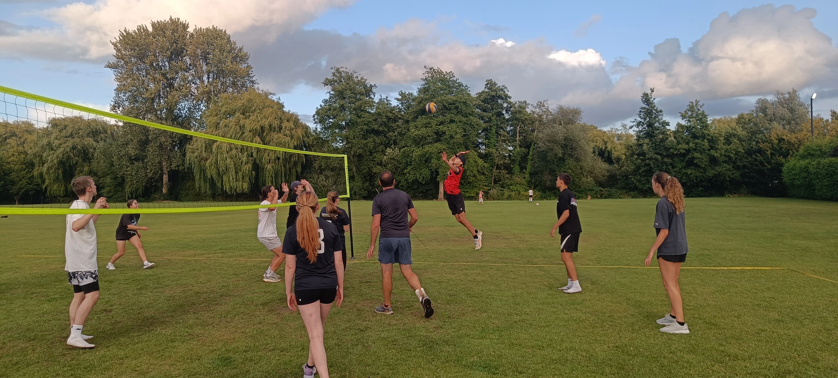 adults playing volleyball outdoor