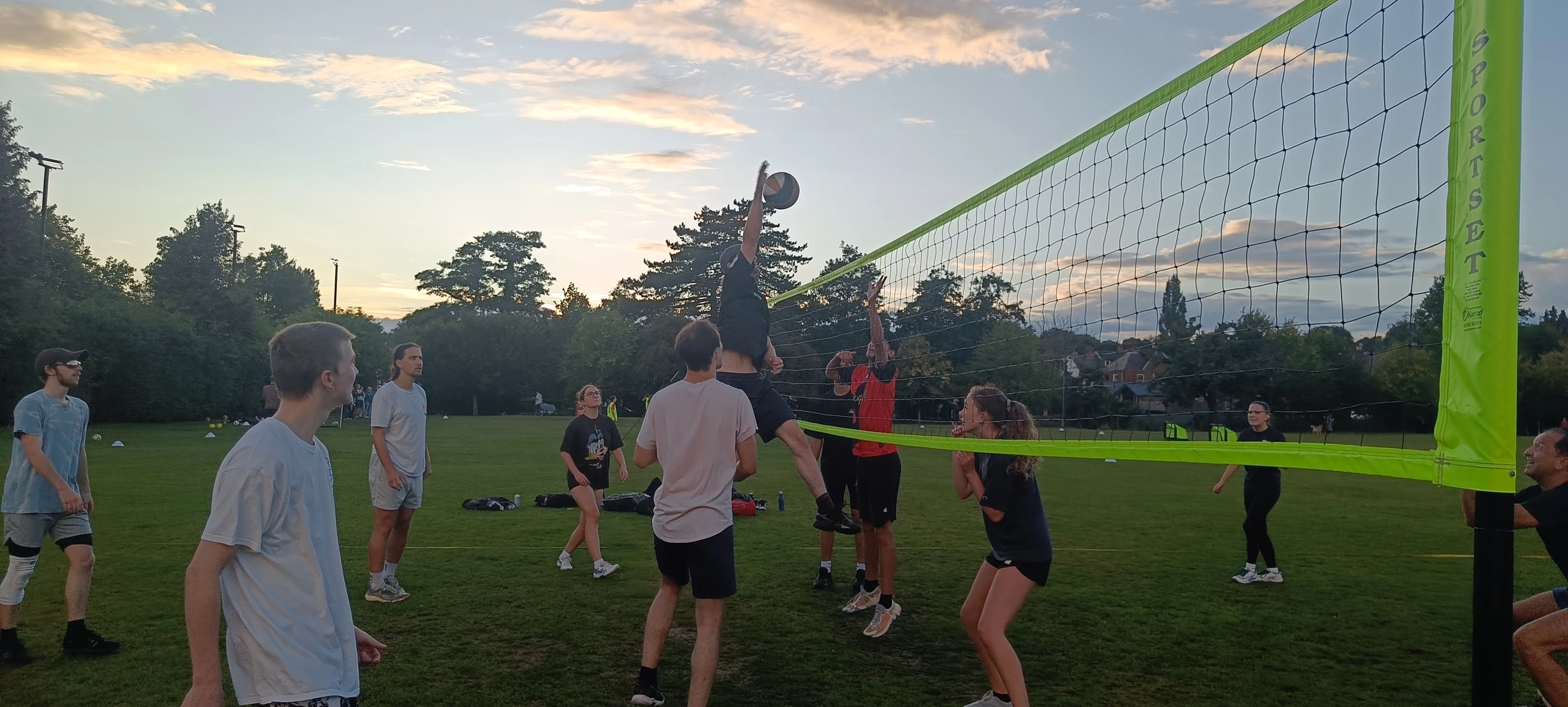 adults playing volleyball outdoor