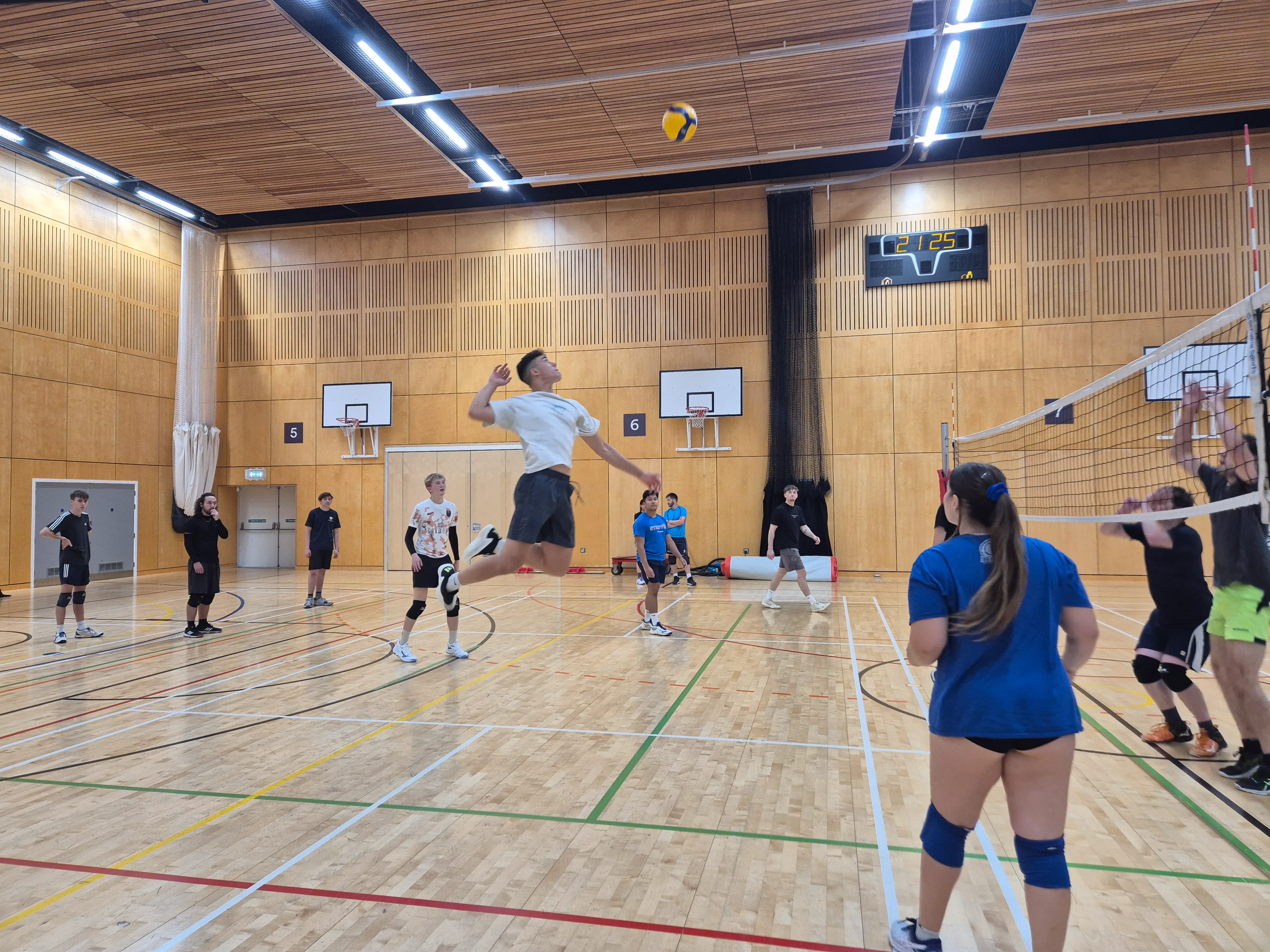 adults playing volleyball indoor