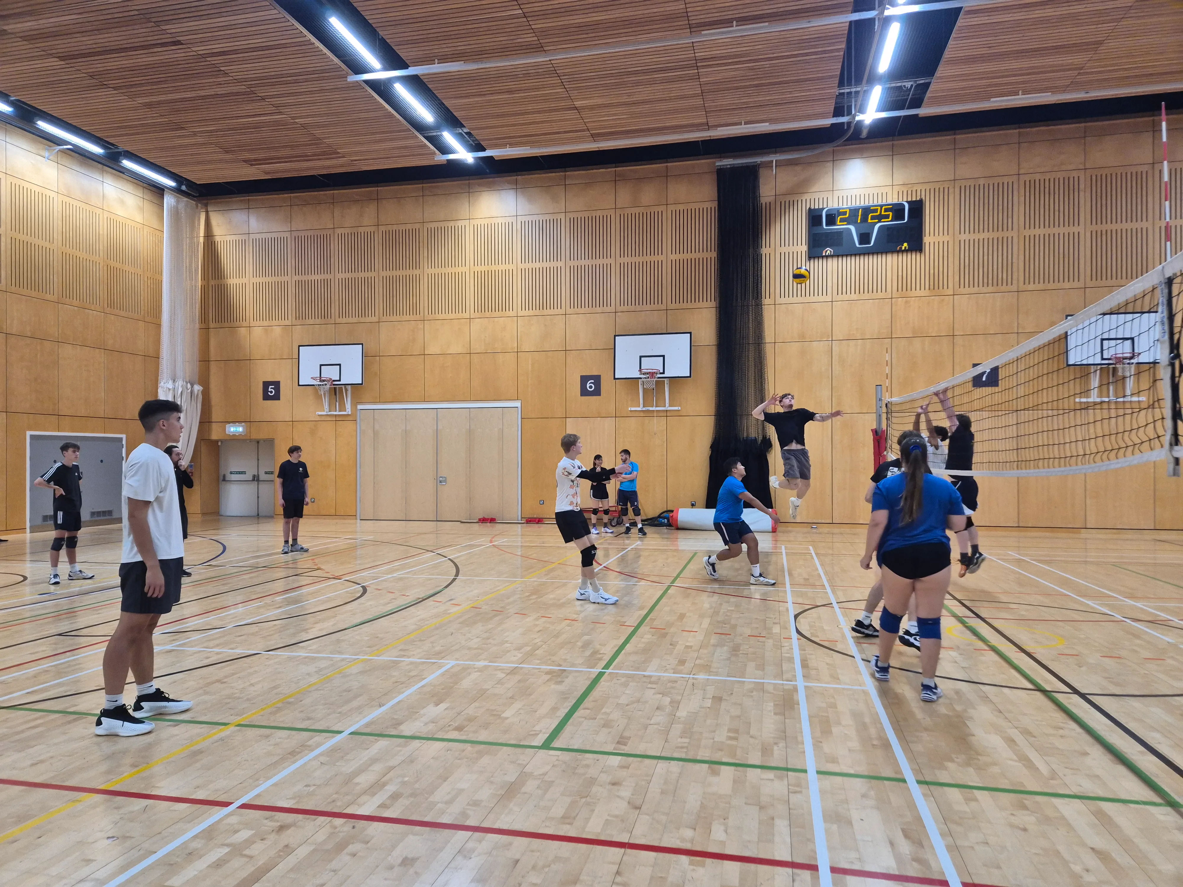adults playing volleyball indoor