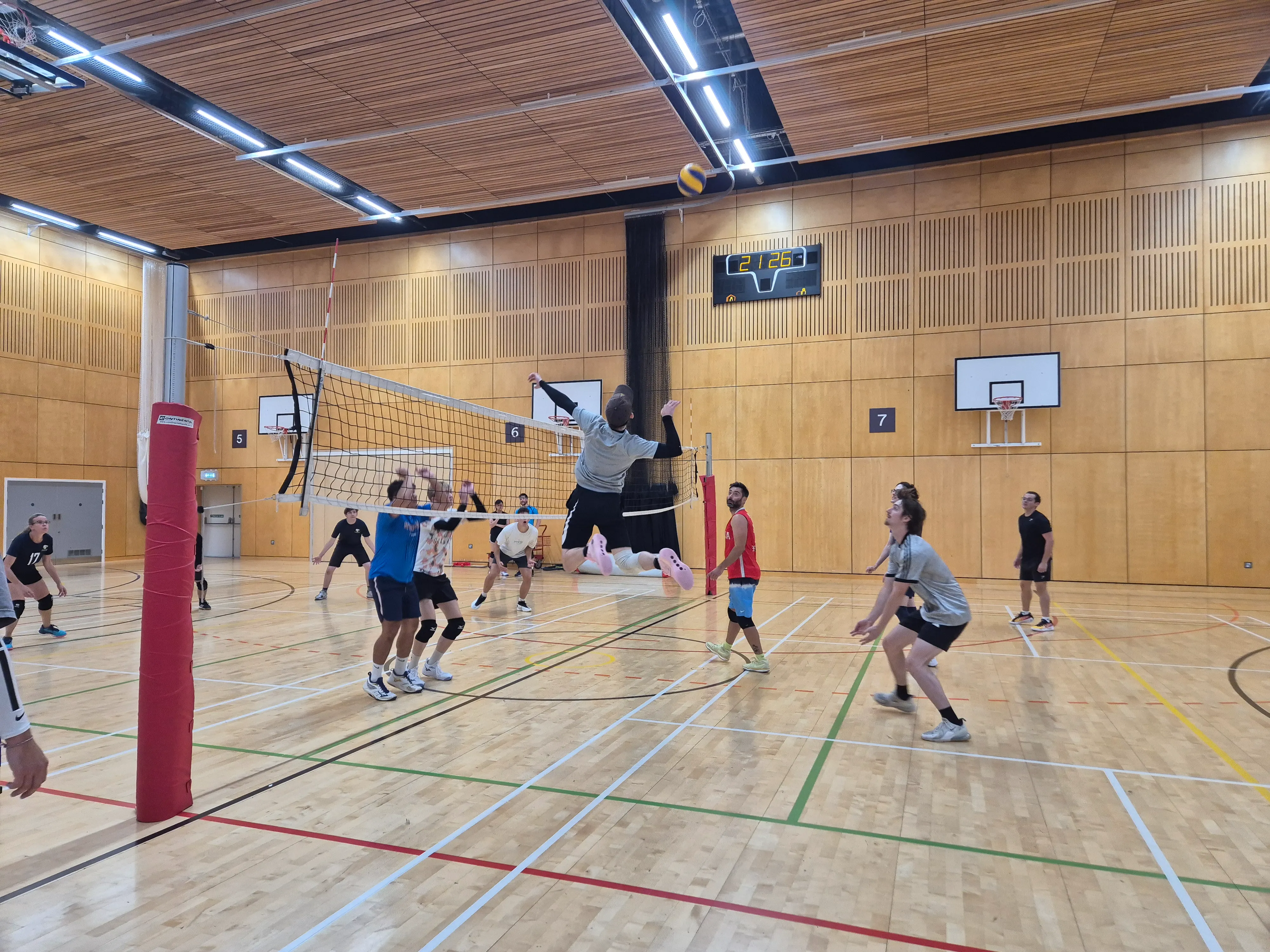 adults playing volleyball indoor