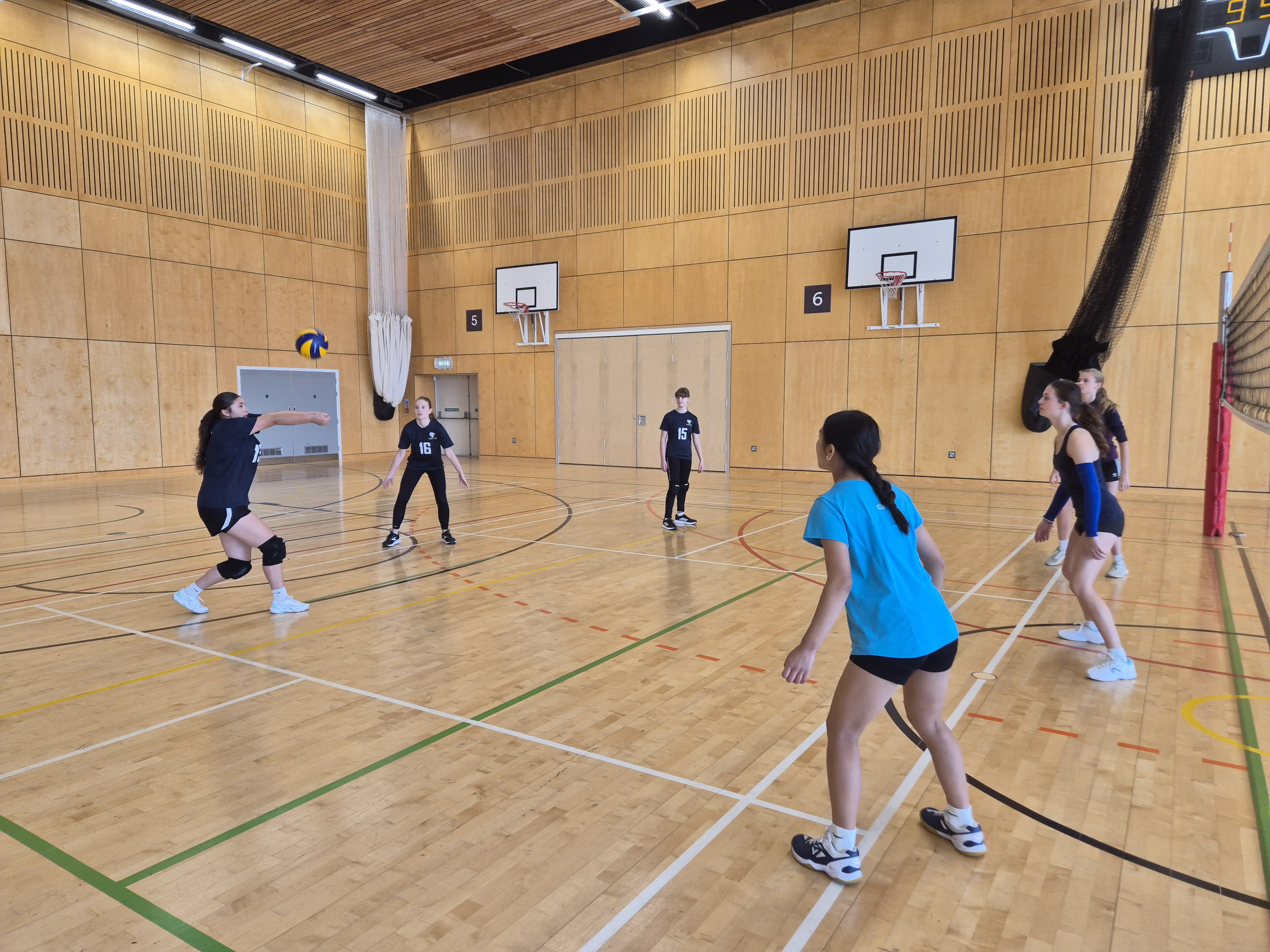 juniors playing volleyball indoor