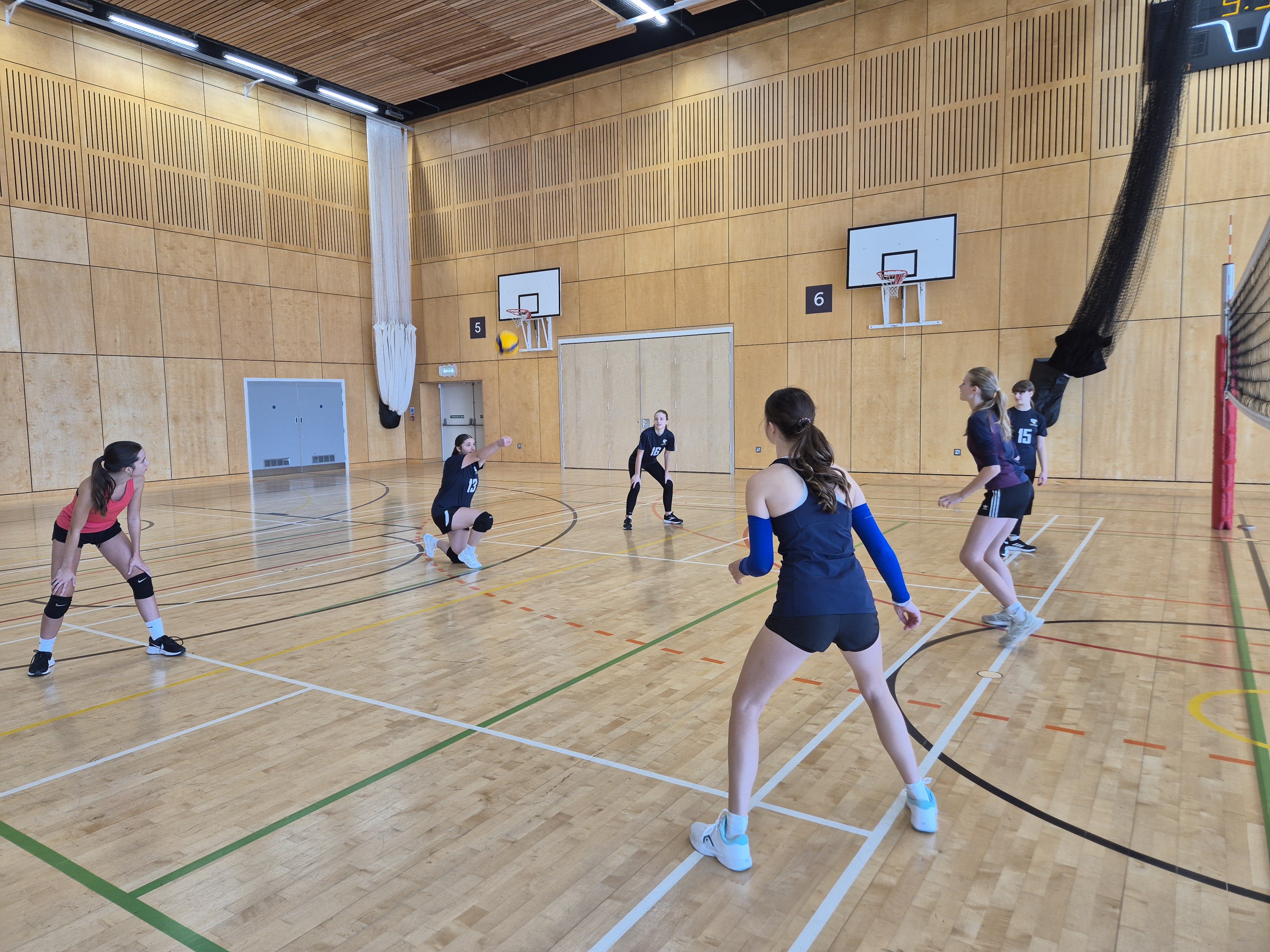 juniors playing volleyball indoor