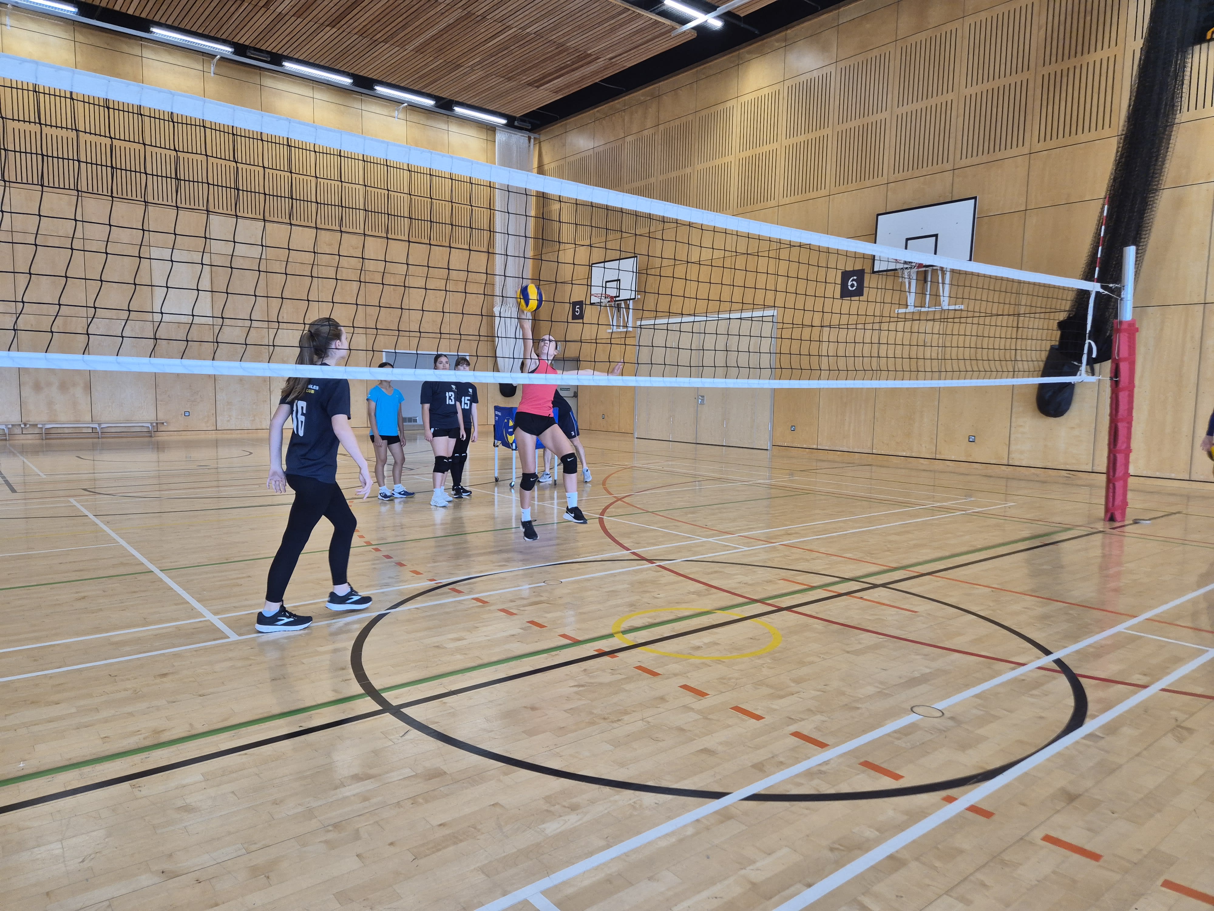 juniors playing volleyball indoor
